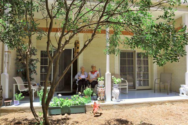 Residents enjoying their apartment patio and the Courtyard