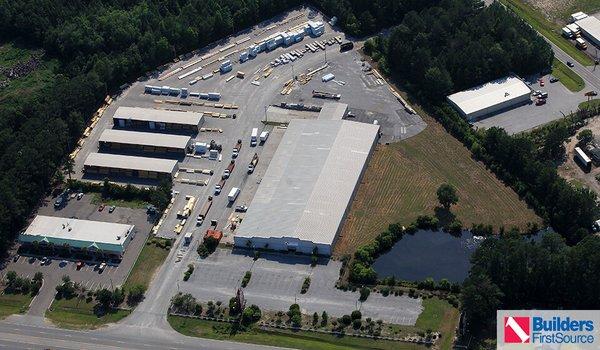 Building materials supplier Builders FirstSource's forklift is moving wood roof trusses.