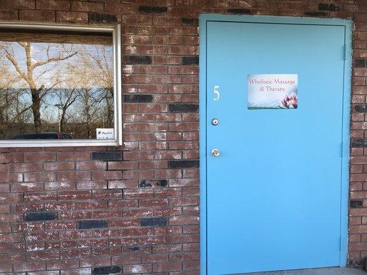 Entrance is the big blue door on the lower level.