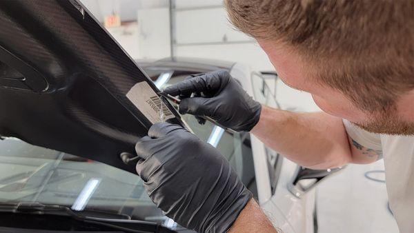 Hand trimming a hood edge after PPF install