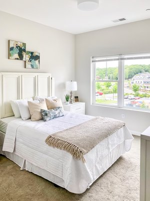 Bedroom with large windows and plush carpeting