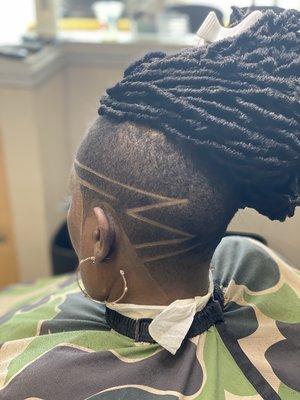 Women's haircut with design.