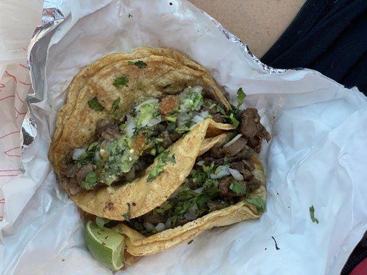 Steak tacos with green and red salsa.