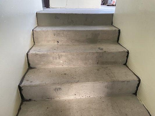 Stairwell that have been drilled on a number of times, that still need to be painted.