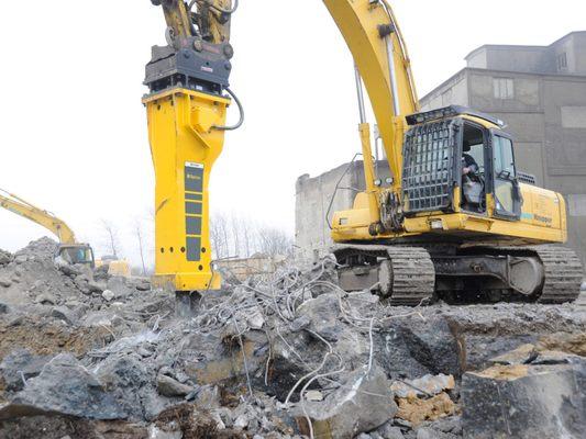 Demolition building, parking lot and houses.