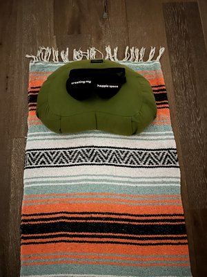 Blanket over yoga mat, pillow and eye mask provided by the studio.