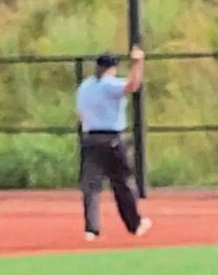 Female ump flipping parents the bird after they spoke out about her screaming profanities at a calm coach in front of young children.