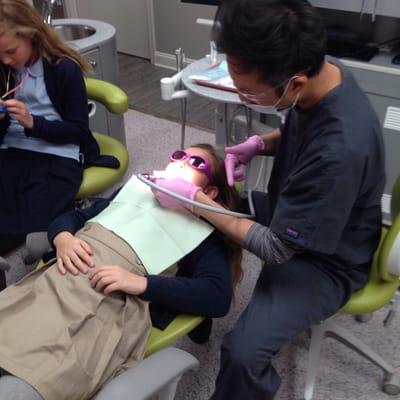 Casual relaxing atmosphere. Dental chair has TV above for kids to view.