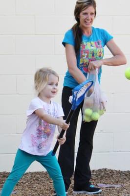 Ms. Tracey teaches us Lacrosse and many other fun games.