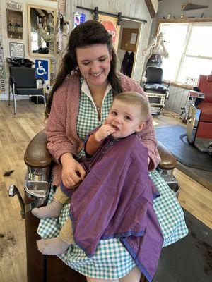 Kiddo getting his very first haircut by Jackie. Despite his grumpy mood, he came out looking like a clean cut little man!