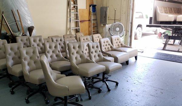 Reupholstered tufted office and wingback chairs.