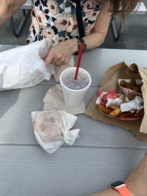 Cheeseburger, tea, and small sides