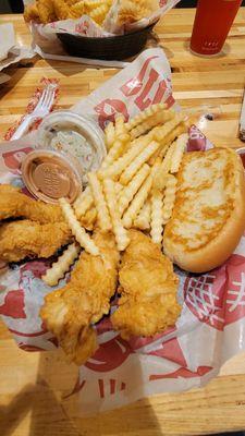 This is the box combo. Comes with 4 chicken tenders, fries, coleslaw, and buttery fluffy toast.  And raising canes sauce.