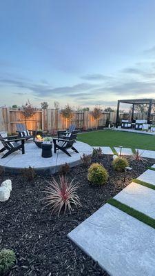 Outdoor design with plants, shrubs, trees, walkways to pergola and firepit areas