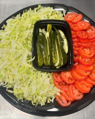 Pairing with our deli platter is fresh tomato, shredded lettuce and crispy pickles.