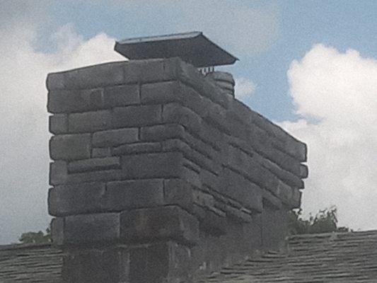 Stone veneer over brick chimney