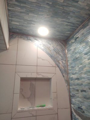 This is a view of the side wall of the shower showing the crest of the mosaic wave going overhead.