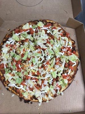 Taco Pizza is here!  A Zesty Taco sauce and Taco Meat After it's cooked it is topped with Sour Cream, Lettuce and Tomatoes!    Delicious!