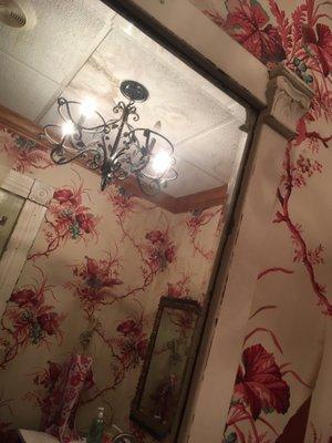 the chandelier and wallpaper in the powder room!