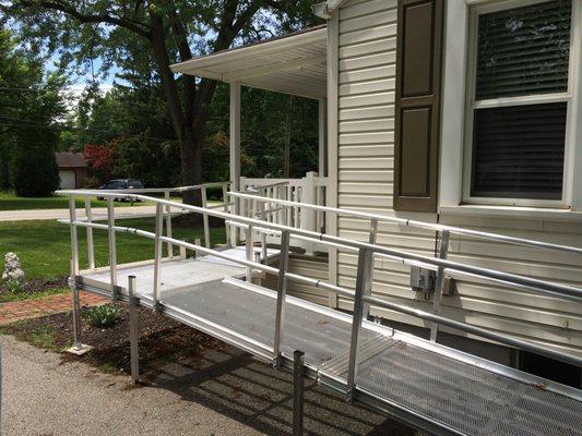 Aluminum modular wheelchair ramp from porch to driveway.