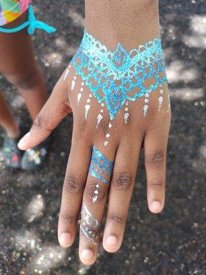 Face painting with a waterproof twist. Glamorous hand drawn glitter tattoos are fun for everyone.