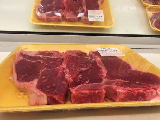 Freshly cut and trimmed T-bone steaks.