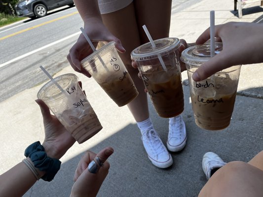 us holding our iced lattes