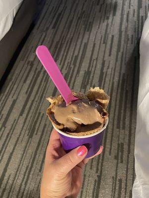 Delicious chocolate ice cream in cup with cone.