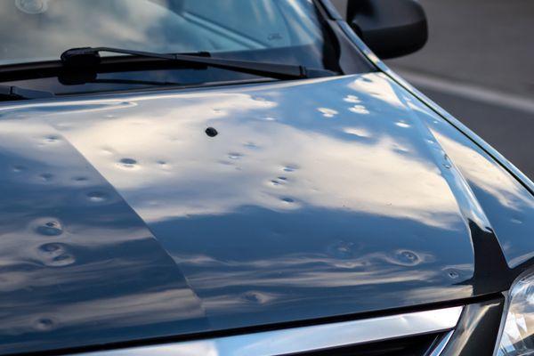 Hail damaged hood of vehicle