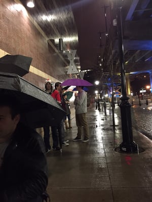 Despite the 14th st overpass being 5 yards away, management insists moviegoers line up in the rain for the Star Wars premiere.