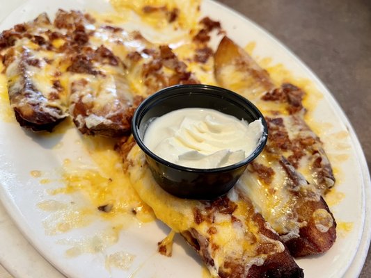 Potato Skins with sour cream. Overcooked and dry with no flavor. First time , last time