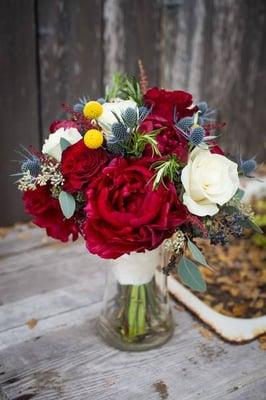 Custom bridal bouquet using burgundy peonies, white roses, blue thistle and yellow billy balls - accented with a hint of Rosemary!