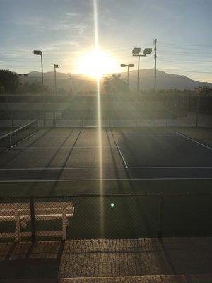 Sun setting over the courts