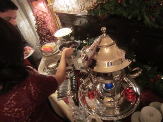 Coffee station with chocolate shavings and whipped cream.