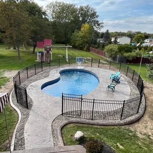 Not only did we install custom concrete curbing around this new pool, we also backfilled with river rock to complete the look.