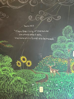 Seasonal Chalkboard Mural in the kids area done by a local young artist.