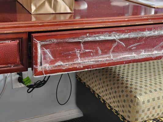 Repaired furniture drawer with scotch tape