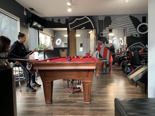 Nice paintings, pool table and hair cutting area.