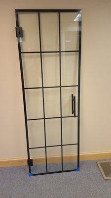 Frameless shower door with matte black hardware