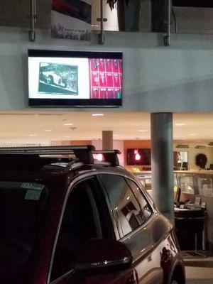 TV in Audi of Charlotte showroom.