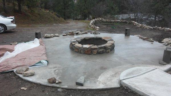 Concrete patio with stone firepit