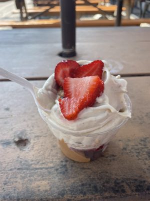 Banana whip with strawberries, peanut butter sauce, and chocolate chips