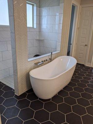 Free Standing Tub on black floor tiles