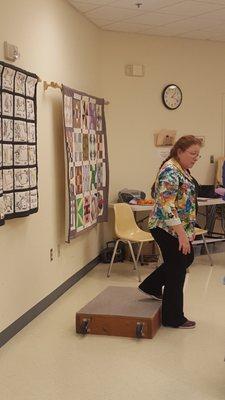 One of our Physical Therapists show the Stepping On Program class at the Frederick Senior Center how to safely step down from a step.