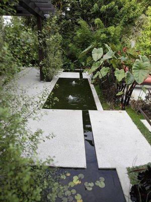 Exposed aggregate concrete fountain with floating bridge