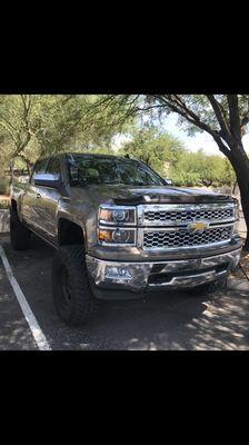 Completed windshield replacement on a lifted Chevy Silverado