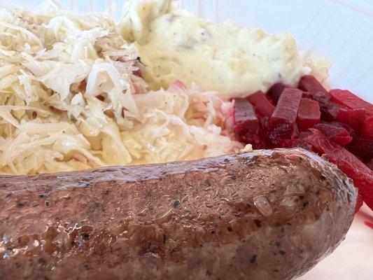 Bratwurst  mashed potatoes  pickled beets and sauerkraut