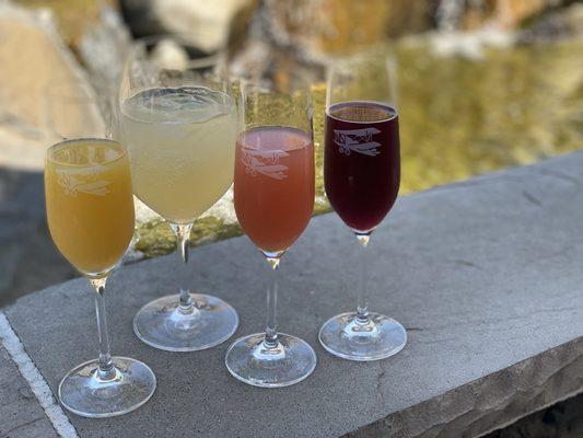 Flight of mimosas with a refreshing glass of of limoncello Perrier on the side