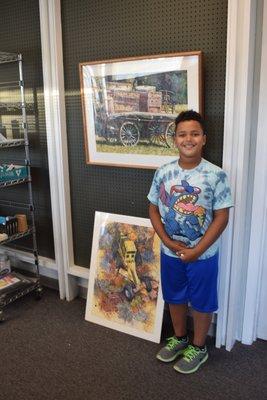 #ArtsNightOut guest standing in front of our Fine Art Client, Craig Cossey's Giclee reproductions! Find out how to make Your Art come alive!