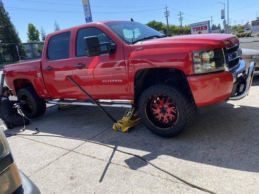 20X12 RED WHEELS 33'' TIRES